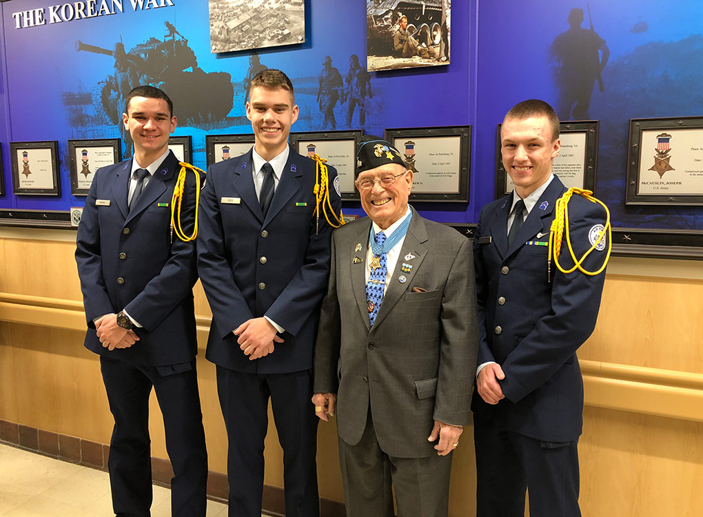 R-MA Falcons Seth Rivera, James Fees, and Jake Hannas with Medal of Honor recipient CWO Herschel 