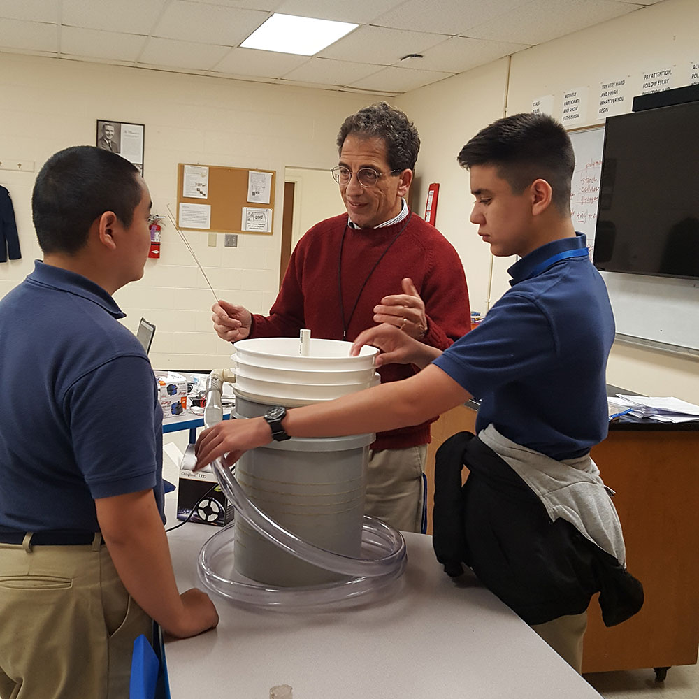 R-MA teacher Dr. Anthony Maranto, center, discusses the physical construction of the combination aquaponics/aquaculture device with students Masaru Mori and Sean Waddell.