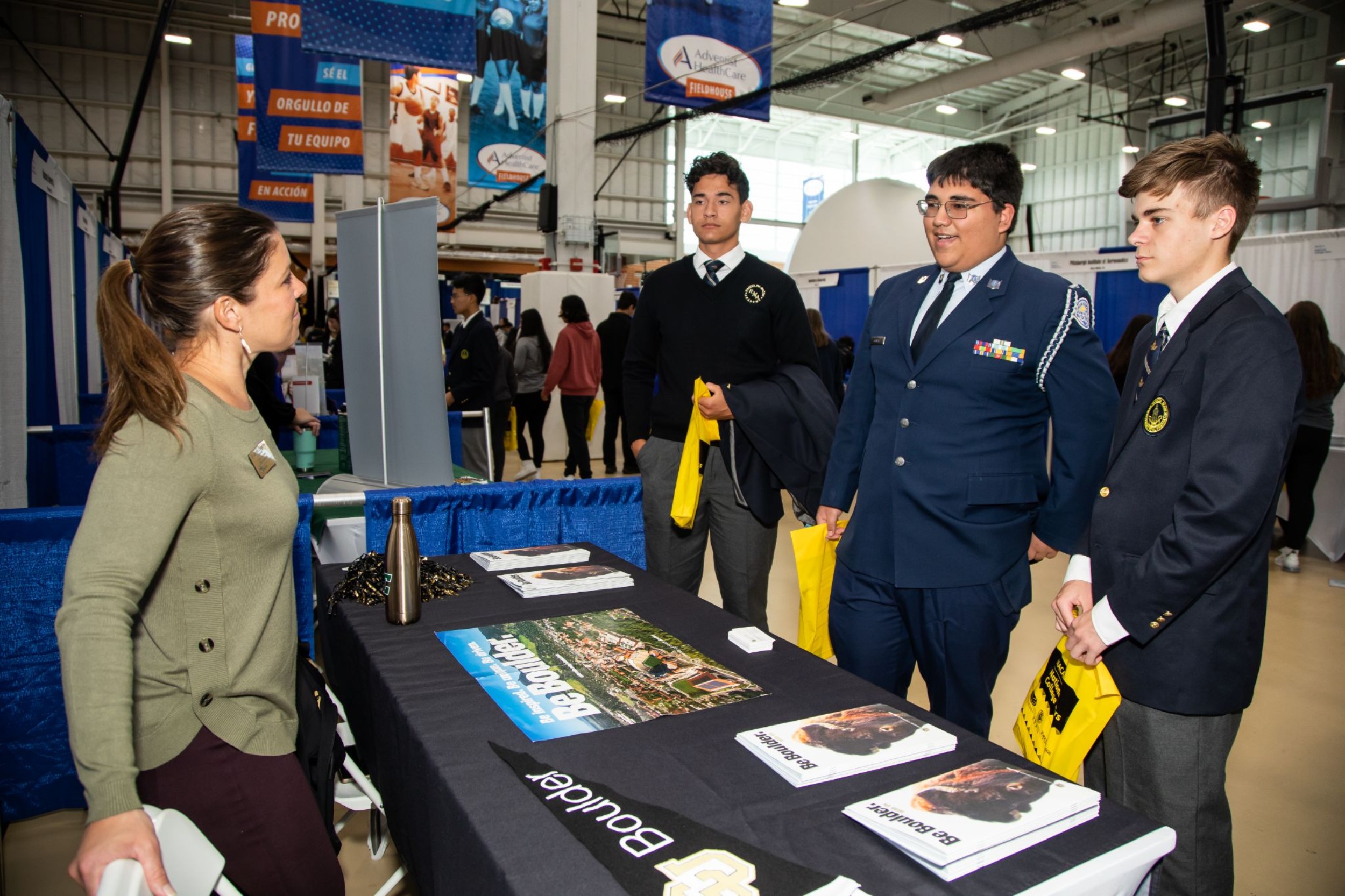 R-MA students interacting with a college representative at a university fair on campus