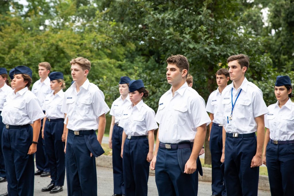 A group of private high school students standing at attention