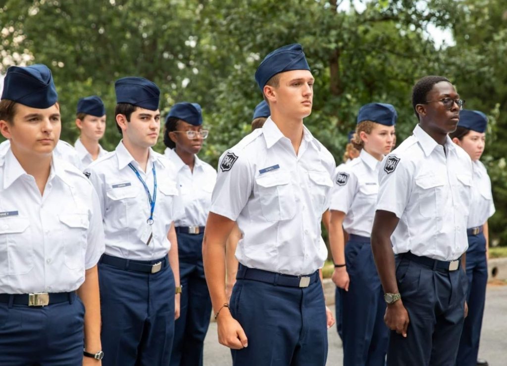A group of students in uniform doing drills at R-MA college prep school.