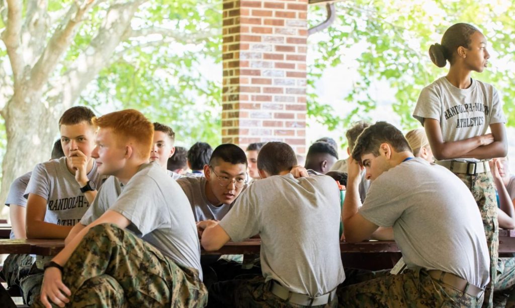 A class of cadet leadership students fellowshipping at a picnic bench