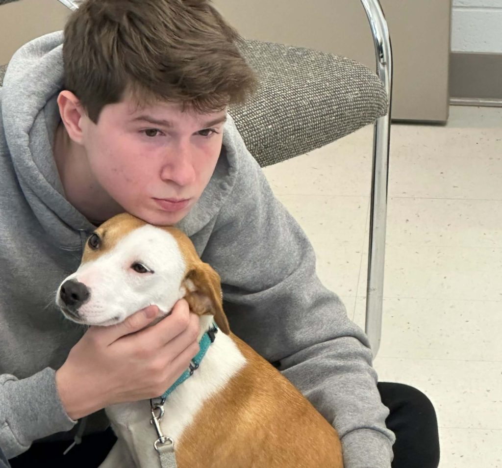 A student at college prep school with a rescue dog