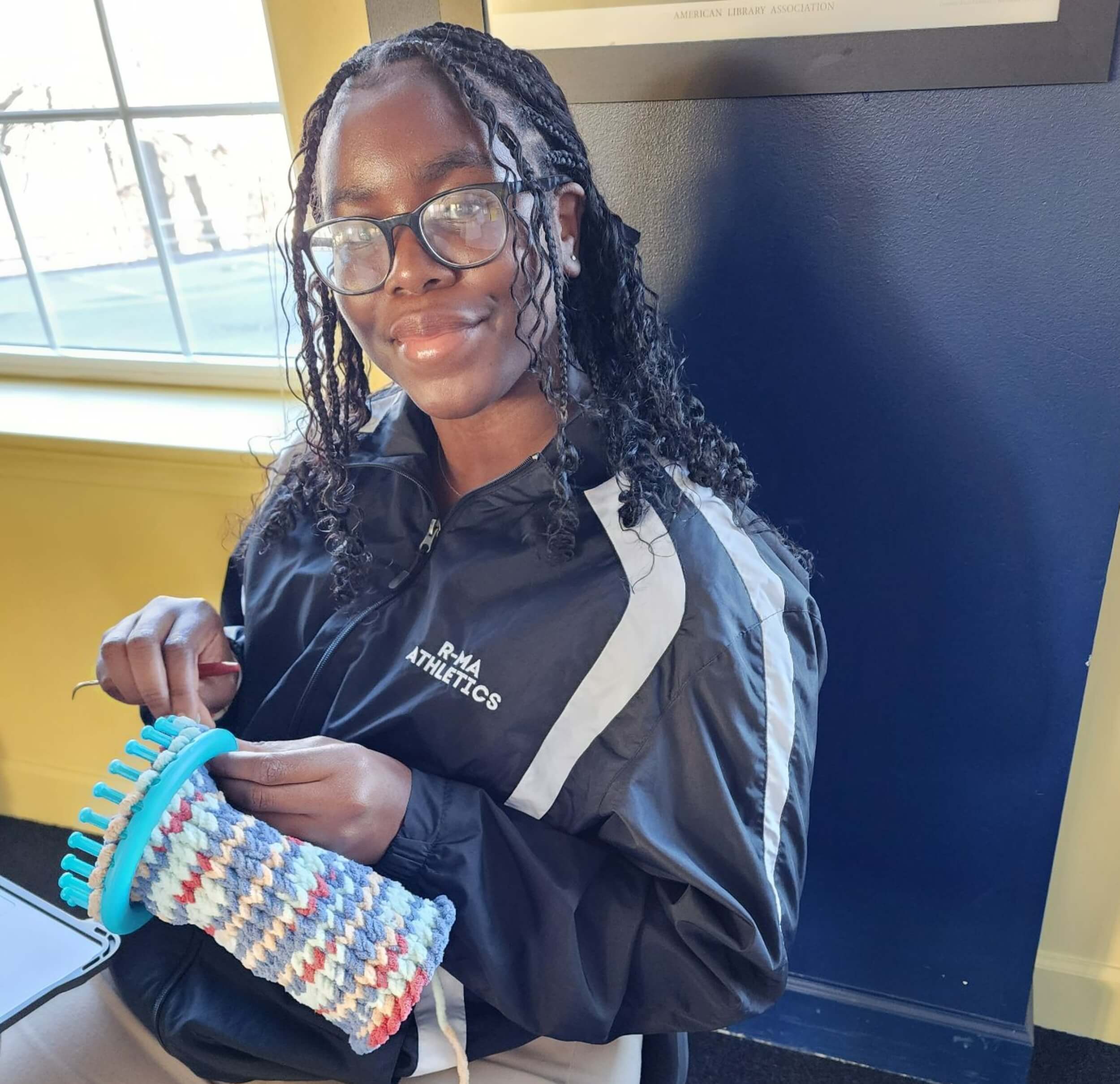 A student at college prep school knitting