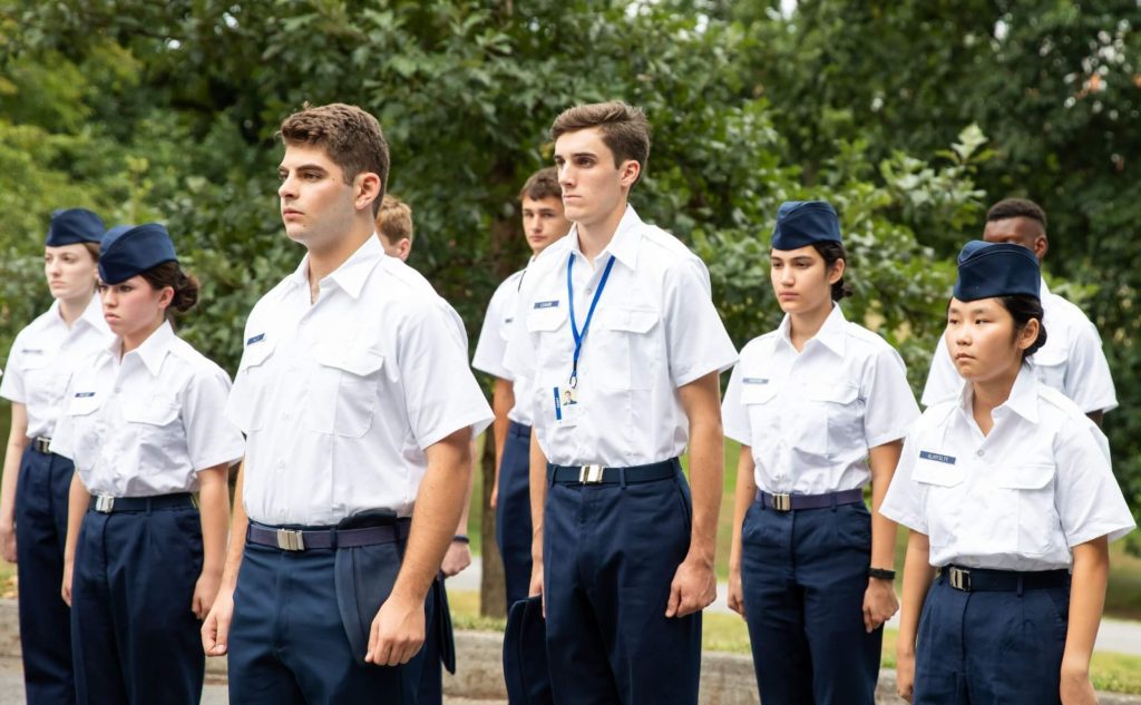 A platoon of cadet leadership students practicing drill outside in uniform