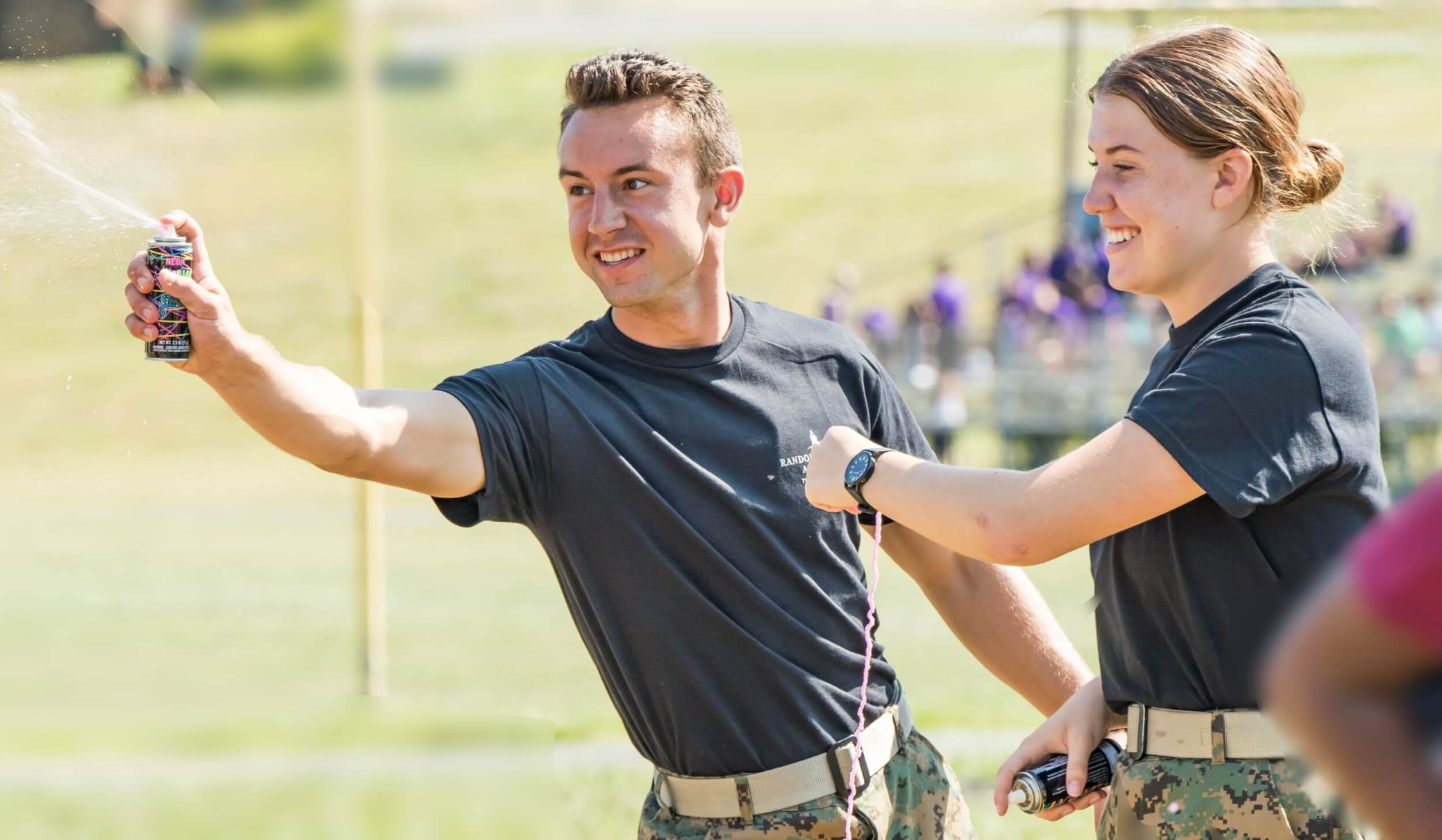 A pair of cadet leadership students working together doing a field activity