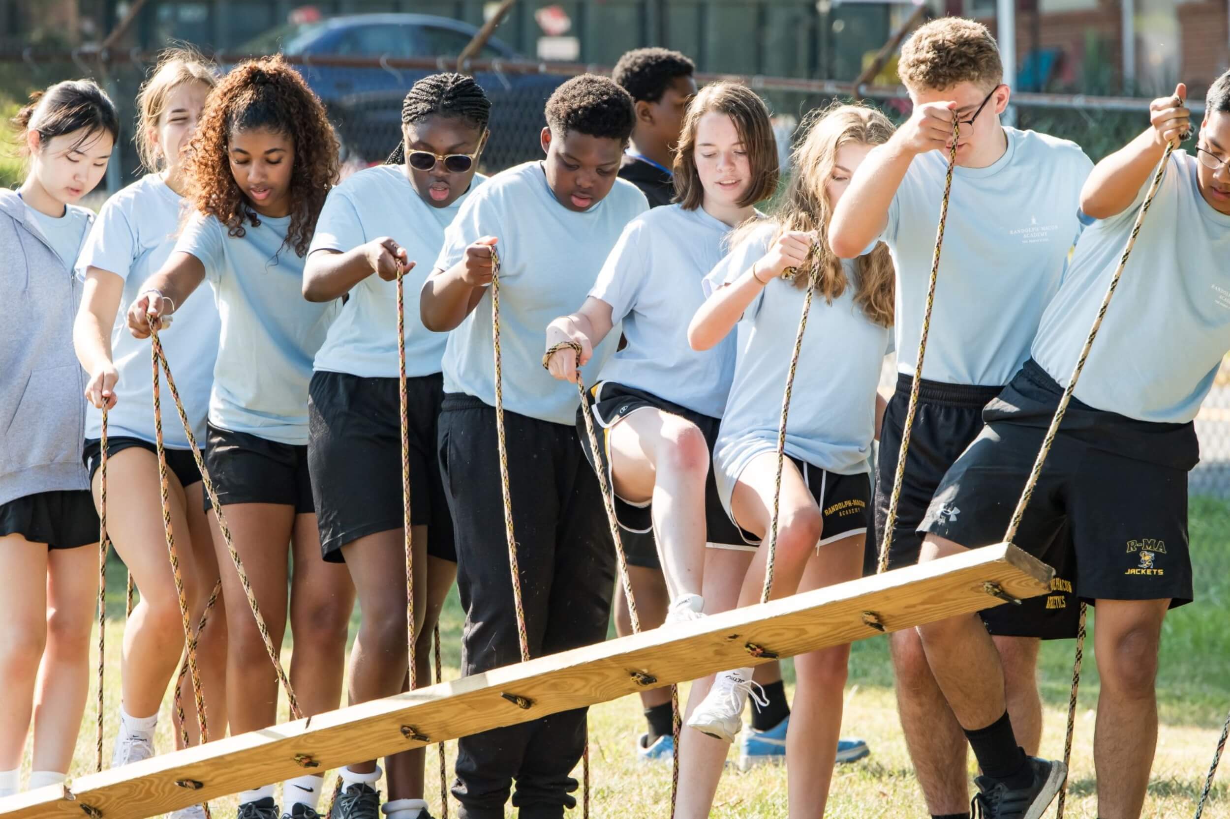 A group of private school students participating in an outdoor group activity