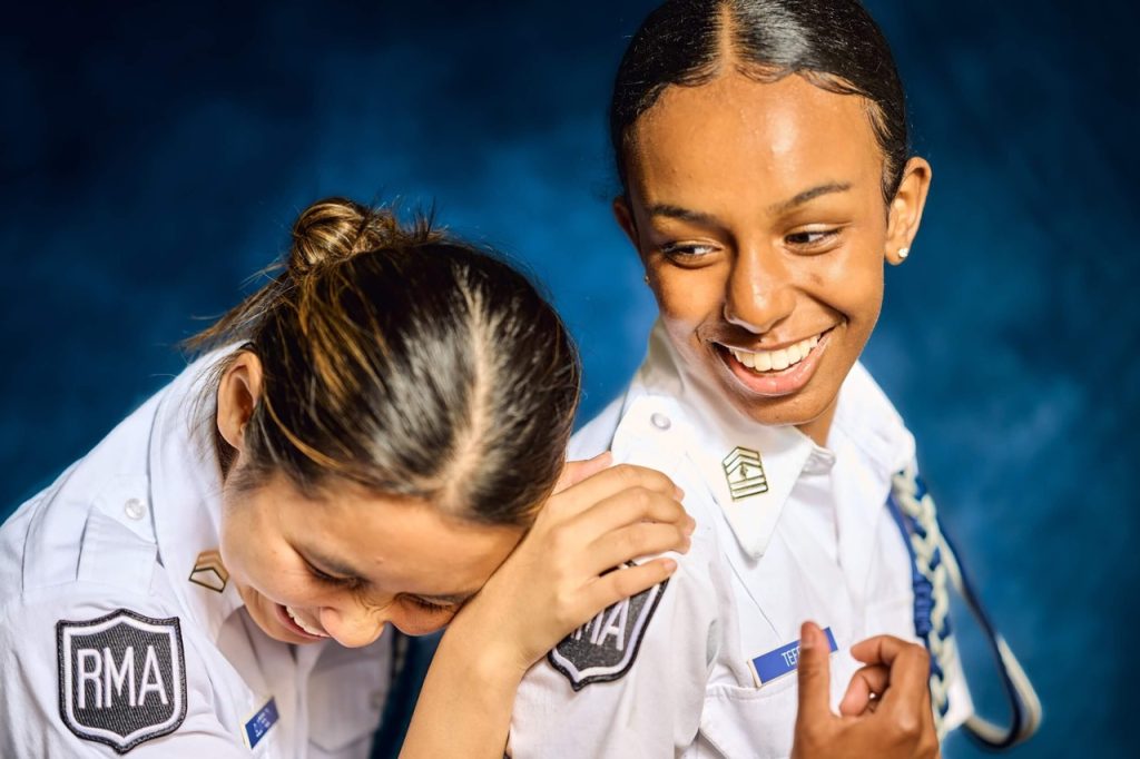 Two women in uniform smiling and posing for the camera.