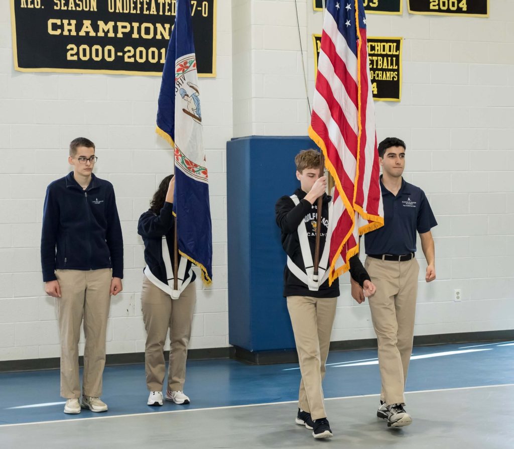 A group of cadets at R-MA hoisting the flag during an event