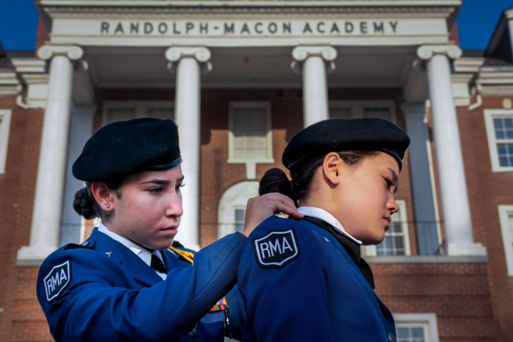 A female cadet assisting another female cadet at our college prep school