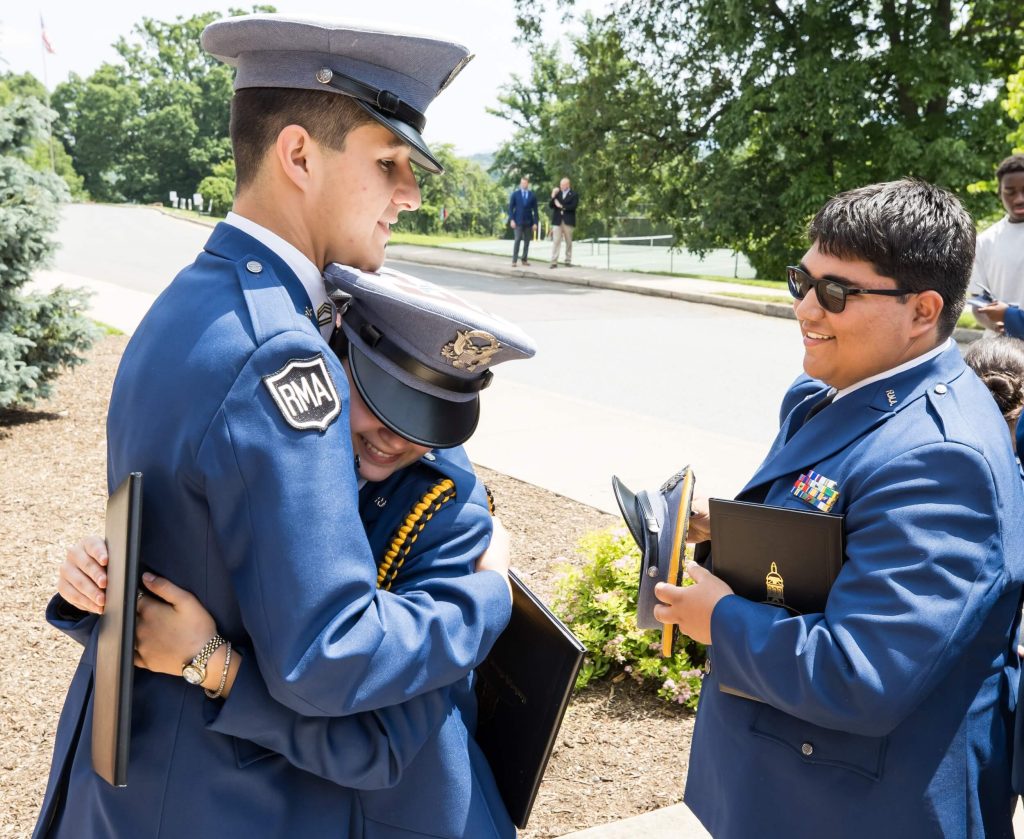 Male cadet celebrating with his colleagues on graduation day at our private school