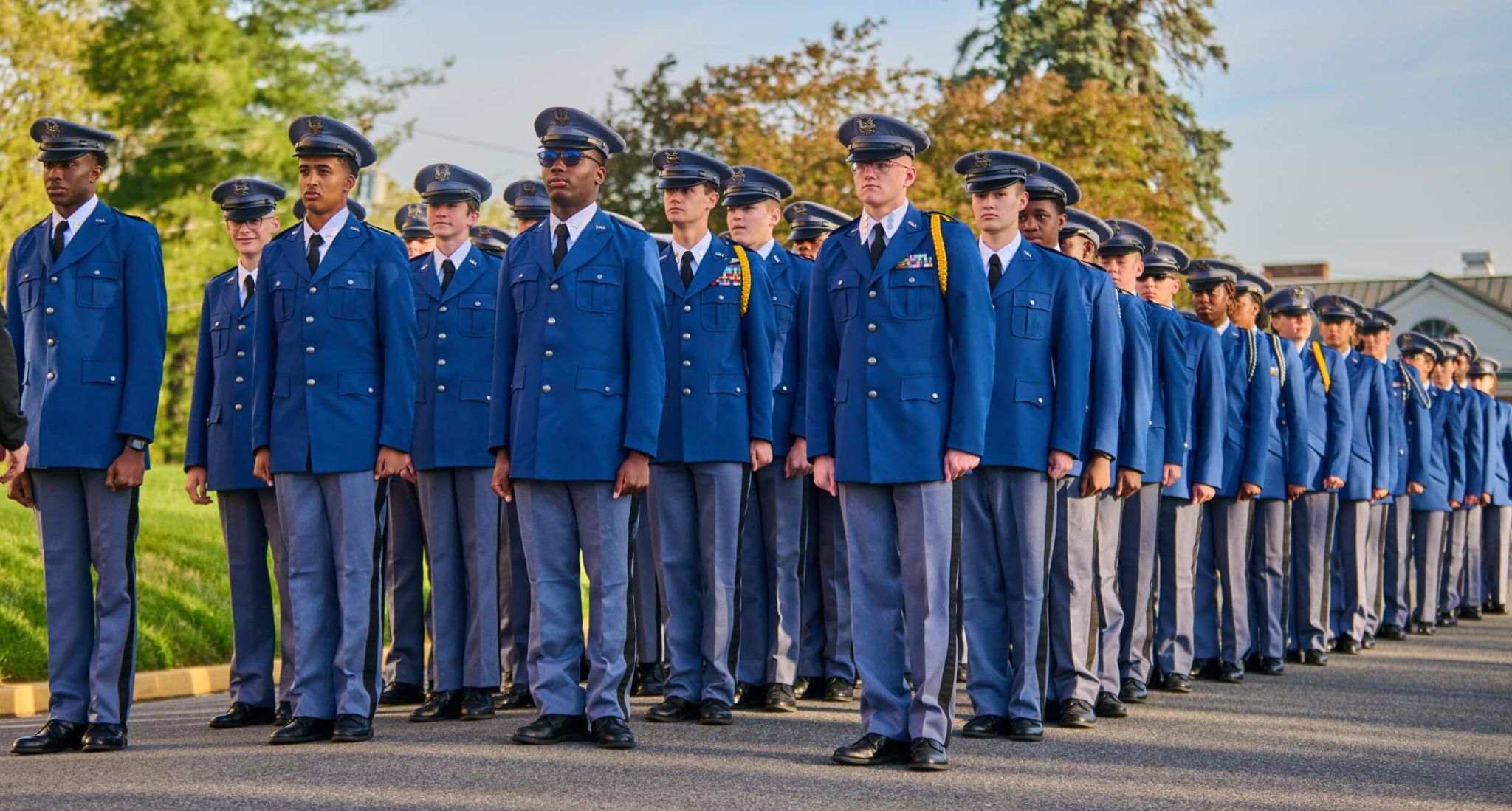 A formation of students in blue cadet uniforms standing in line at our college prep school, showing discipline and college readiness success