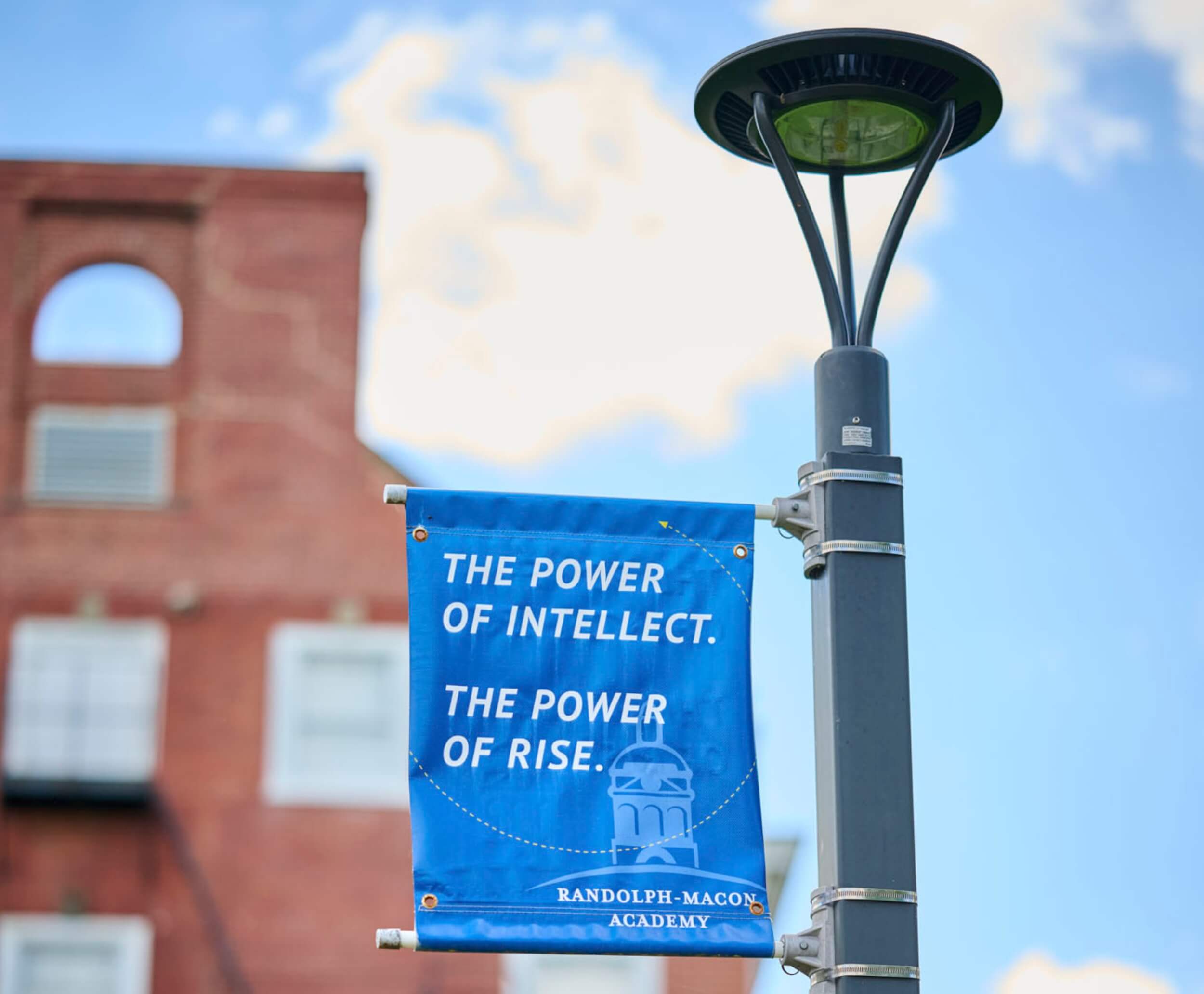 A Randolph-Macon Academy campus banner reads “The Power of Intellect. The Power of Rise,” promoting college readiness success.