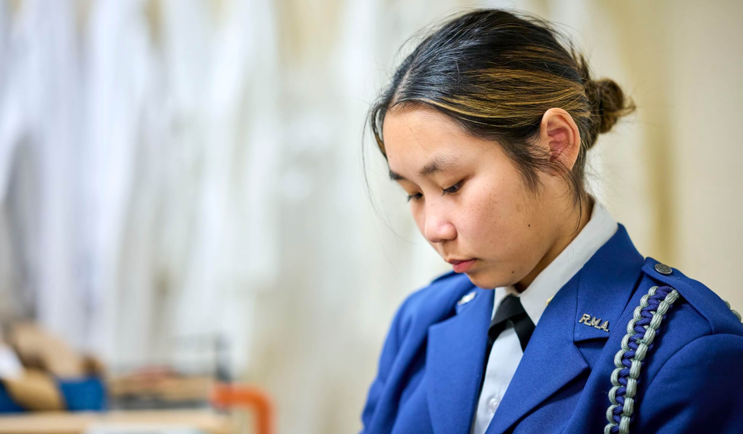 R-MA student organizing textbooks and notebooks on a desk