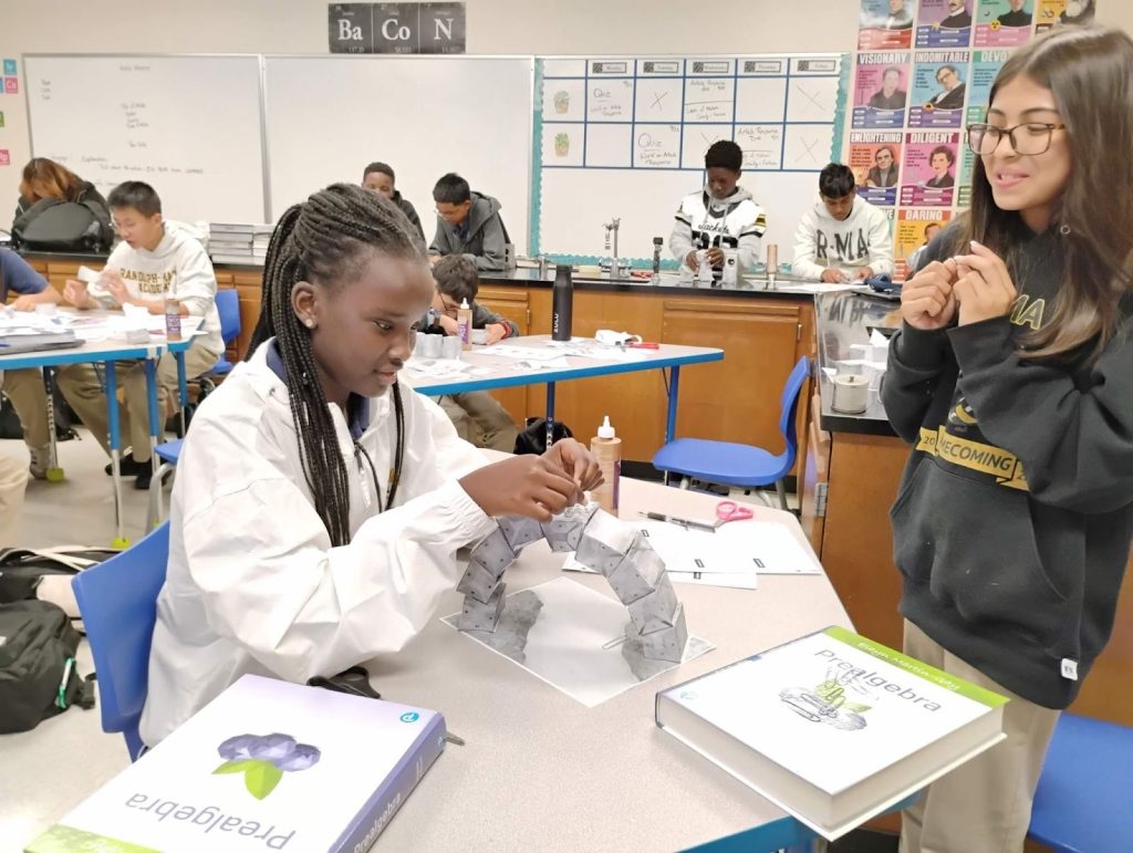 A class of students at R-MA’s 8th-grade boarding and day during a robotics lab.