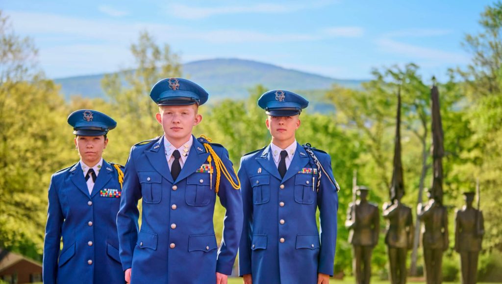 A trio of military school transfers in uniform practicing formation