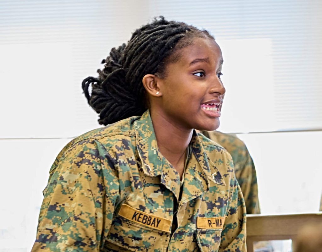 A student leader guiding peers during a character and leadership activity