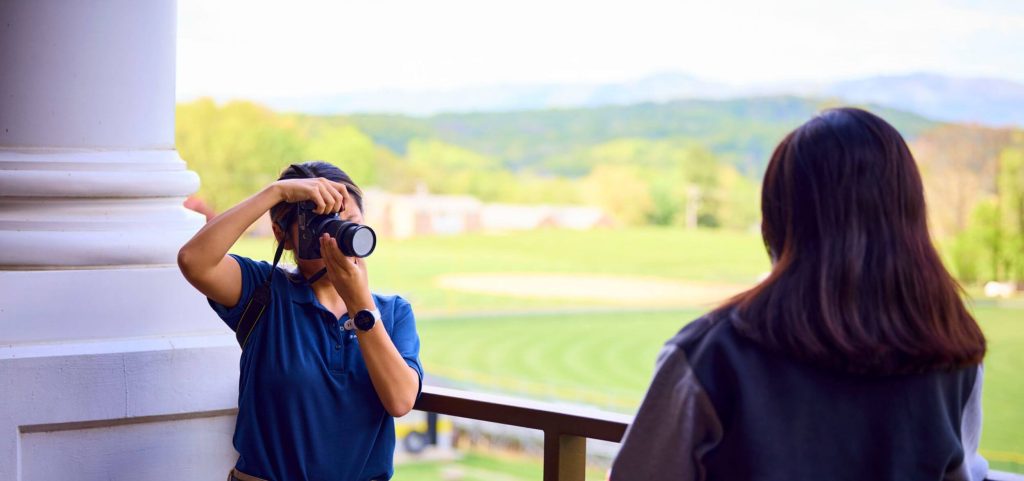 A student photographer capturing a moment for a yearbook at a performing arts boarding school