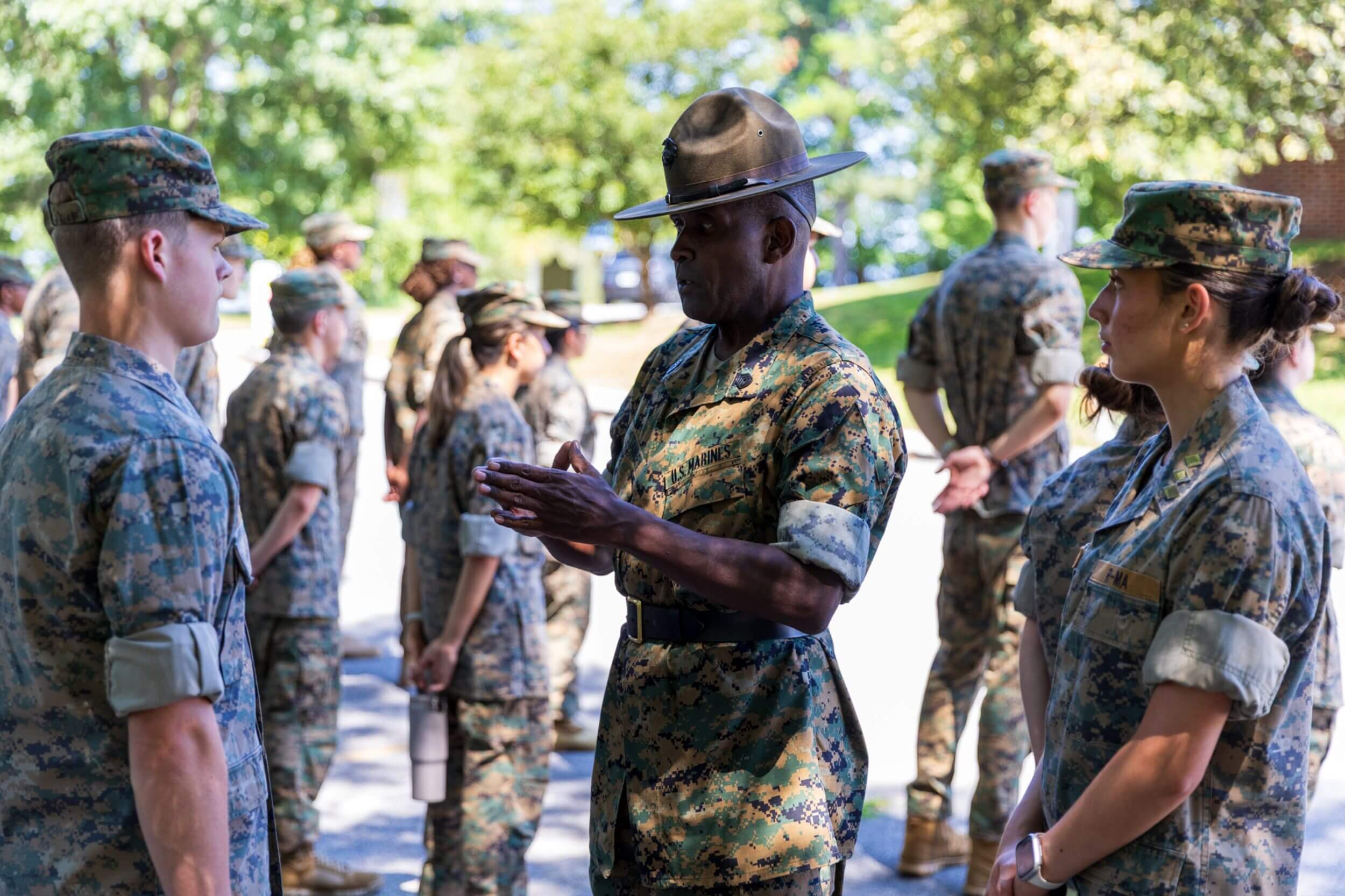 Students participating in team-based field exercises during summer military programs at R-MA.