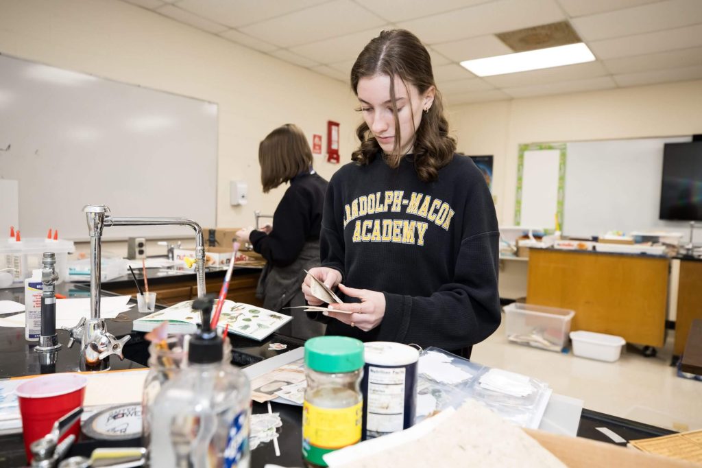 A student working with learning materials in a science classroom during a summer academic program at R-MA