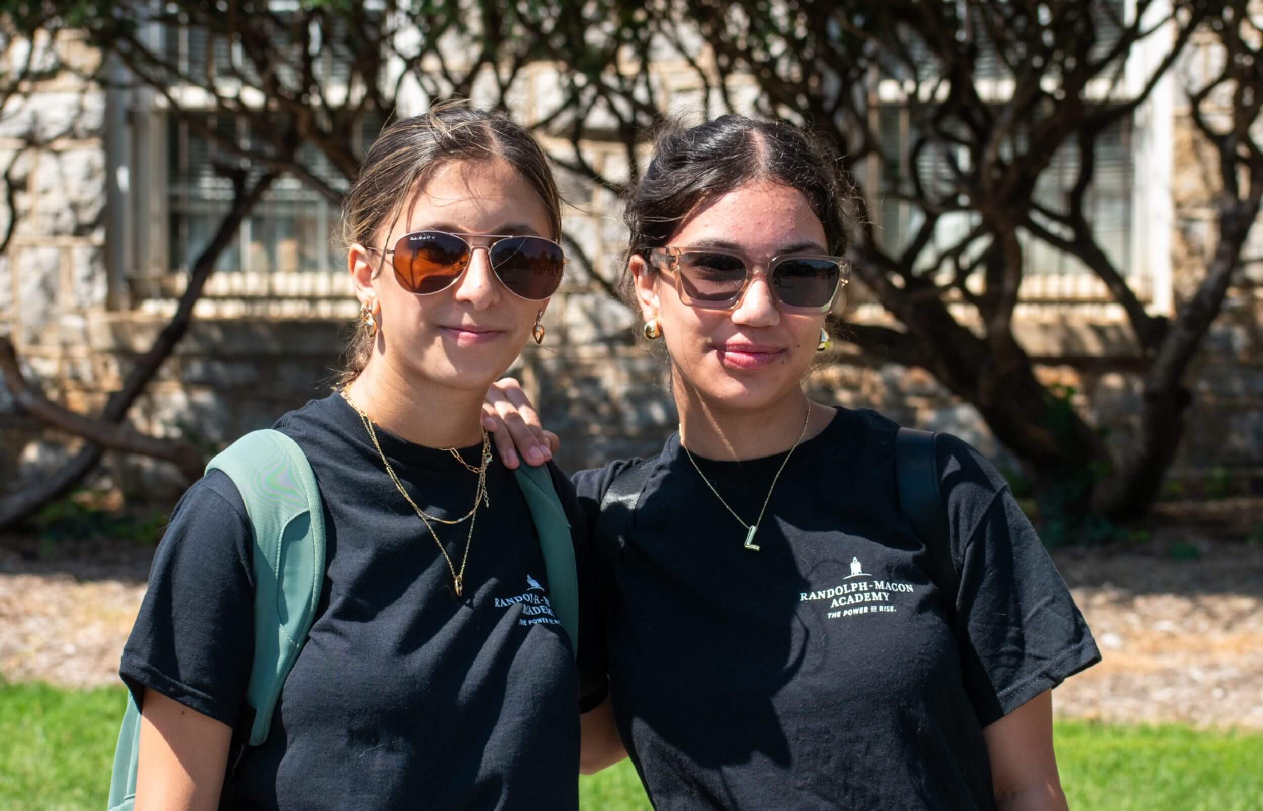 Two students standing outdoors on campus during a summer academic program at R-MA