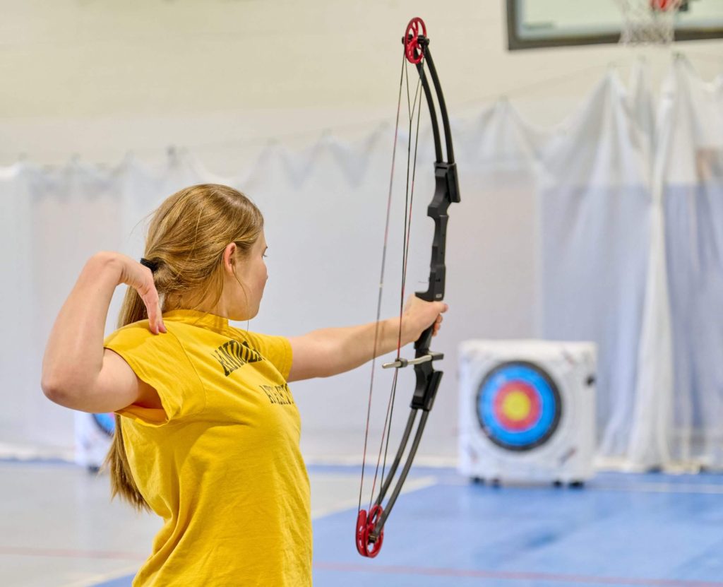 A group of students enjoying outdoor summer activities together on campus