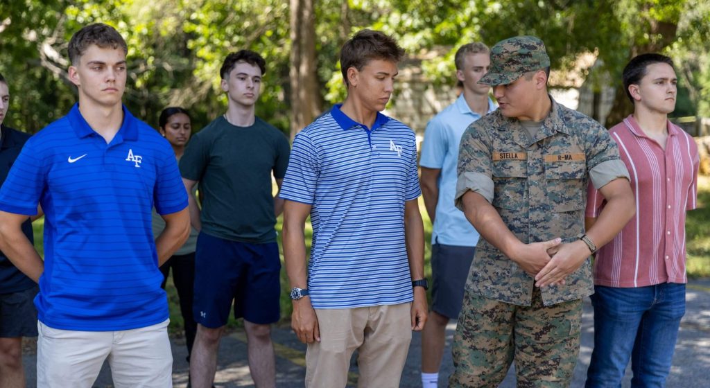 An R-MA student mentor guiding peers during an outdoor leadership activity, highlighting mentorship for high school students