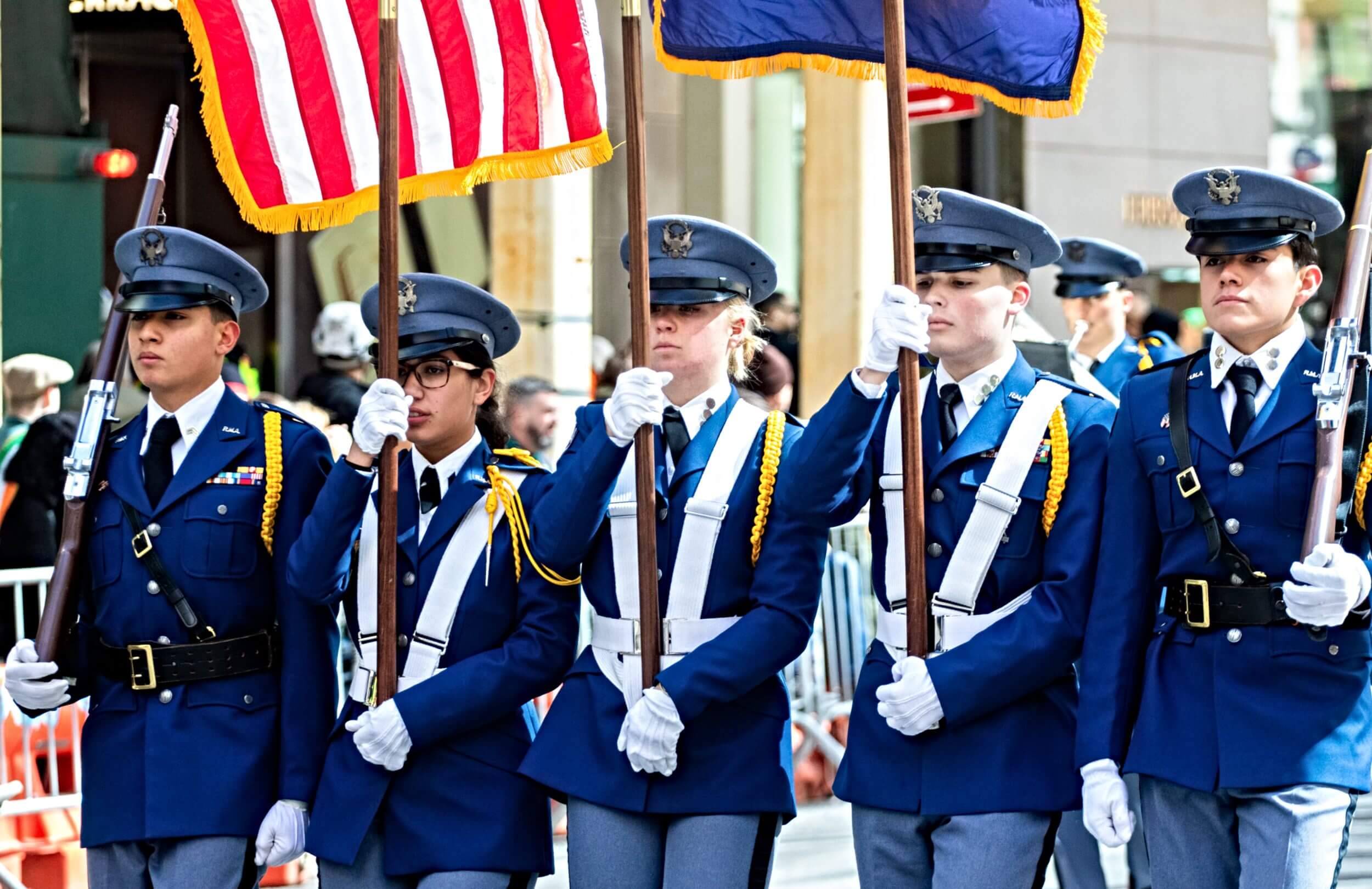 R-MA cadets in uniform carrying flags during a school event, reflecting leadership and structure within pre-professional pathways