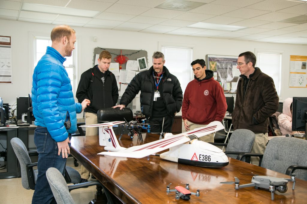 Students participating in a STEM aviation program examine drones and unmanned aircraft systems during a hands-on aviation class at Randolph-Macon Academy.