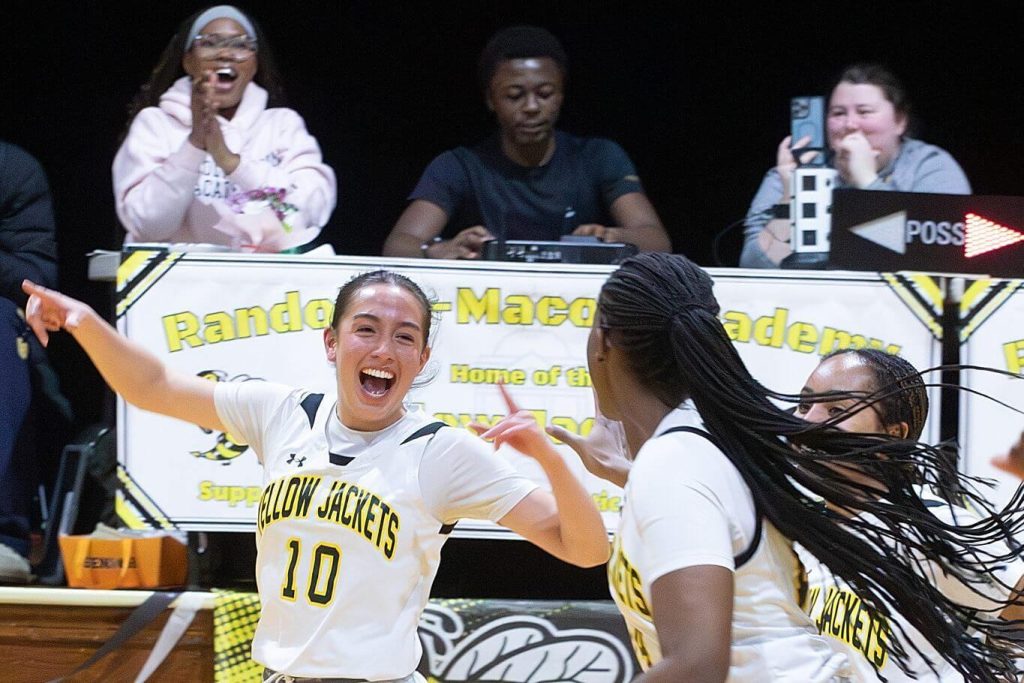 A pair of R-MA student athletes celebrating during a game, showing confidence and student academic support through a structured school environment