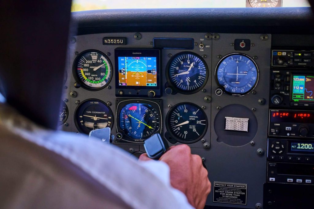 A student operating aircraft controls during a flight lesson in Randolph-Macon Academy's high school aviation program, applying STEM skills and aviation training.
