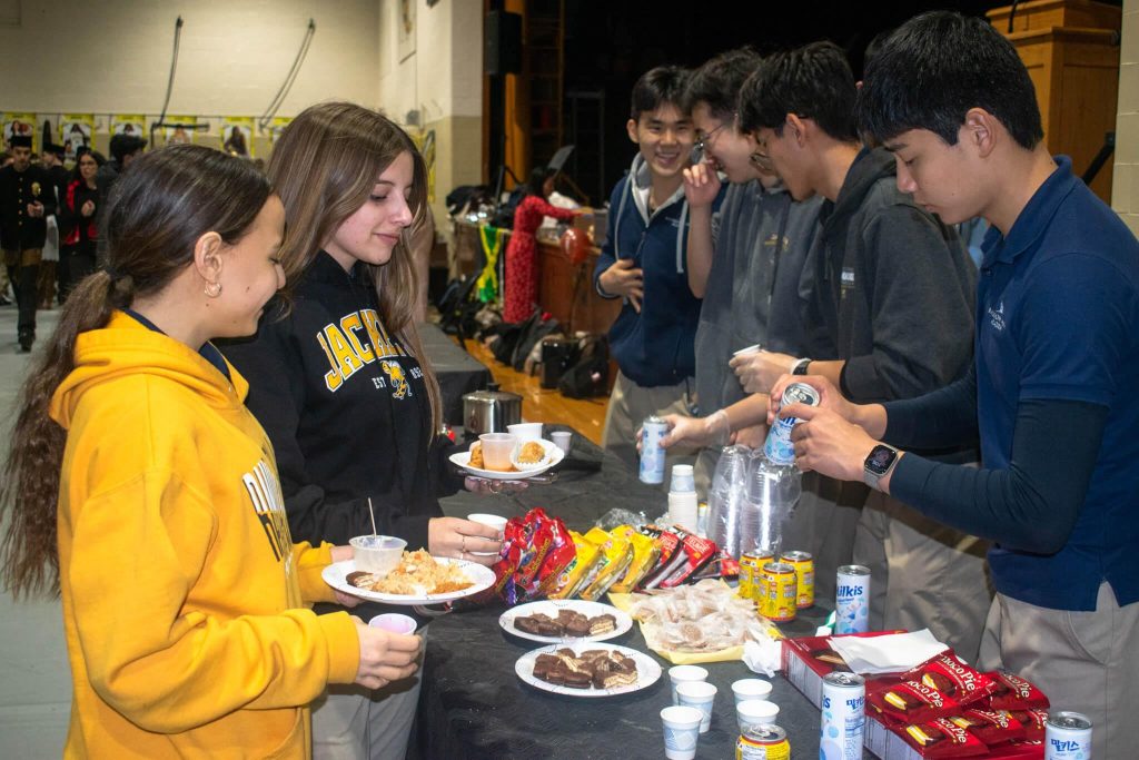 R-MA students sharing food and socializing at a school event, building friendships and community while adjusting to boarding school.