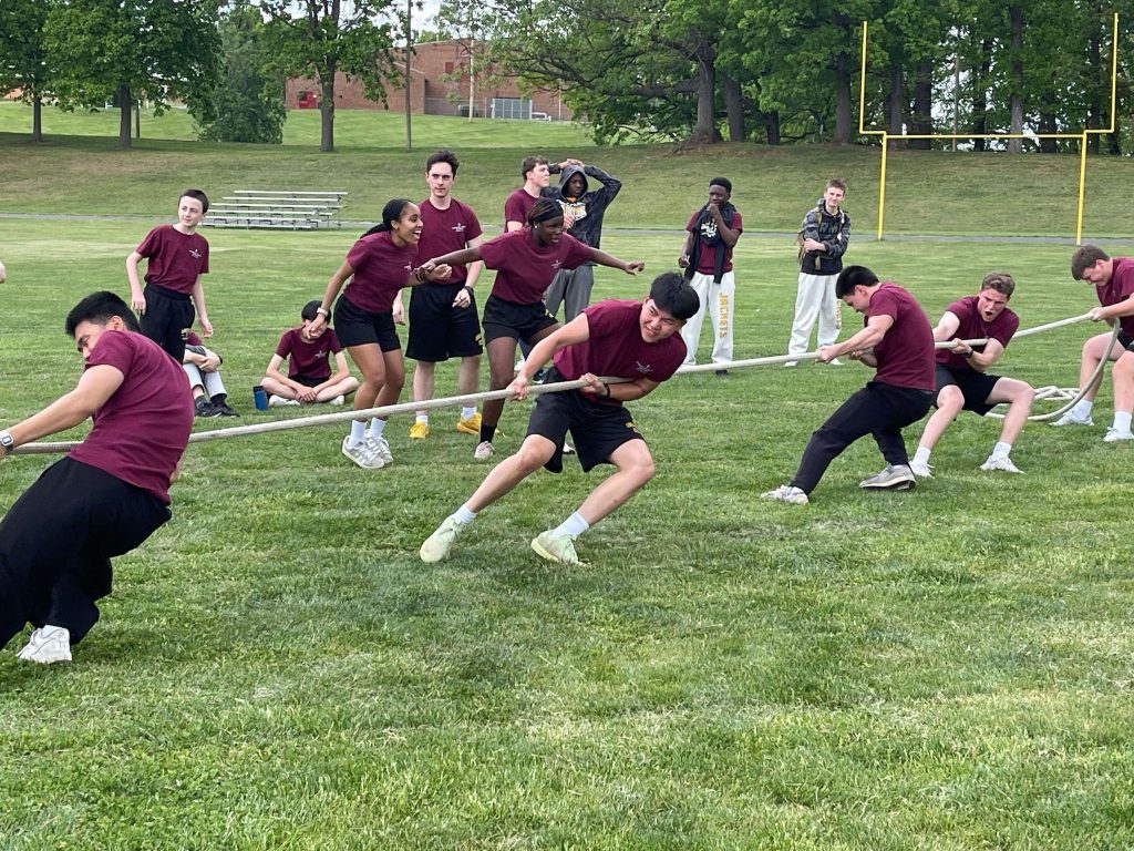 Randolph-Macon Academy students participating in a tug-of-war team activity that encourages friendship, teamwork, and boarding school community involvement.