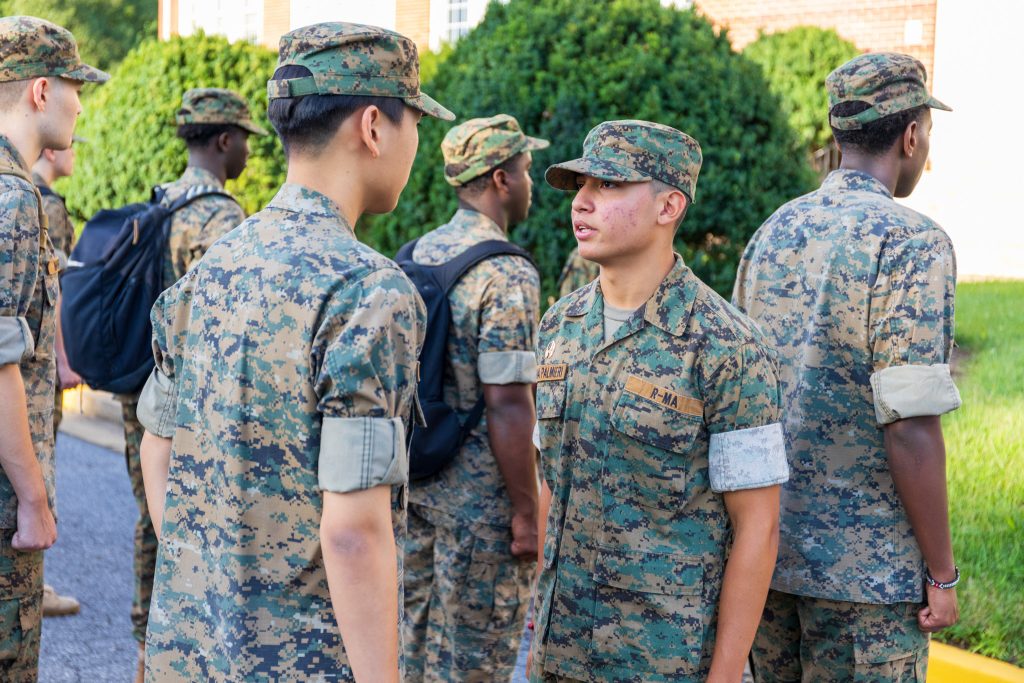 An R-MA student speaking to fellow cadets during a group session, demonstrating communication, confidence, and active participation.