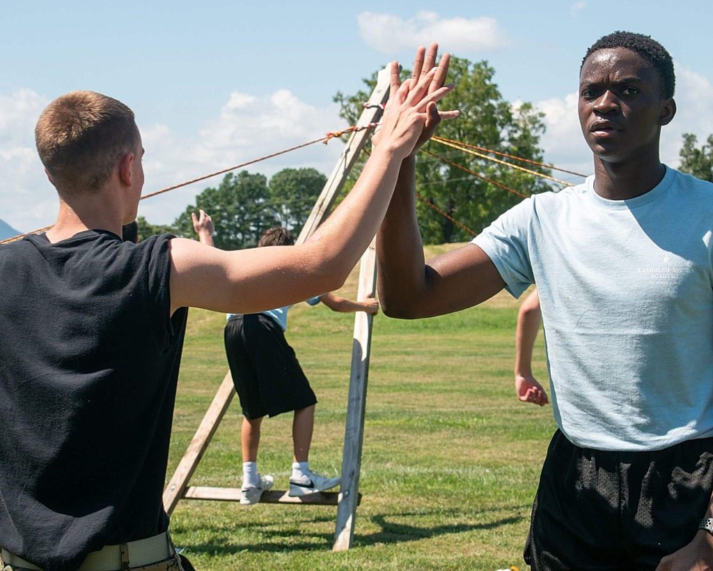 Randolph-Macon Academy students completing an outdoor teamwork challenge that develops leadership and collaboration.