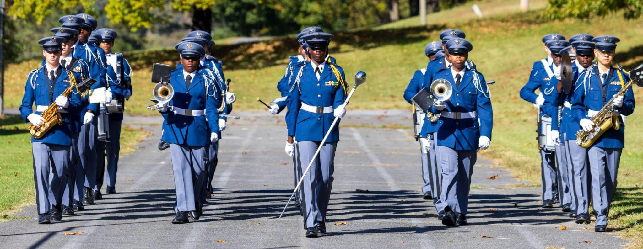 Students in uniform marching together during a school event, demonstrating extracurricular activities for high school students, and teamwork at R-MA