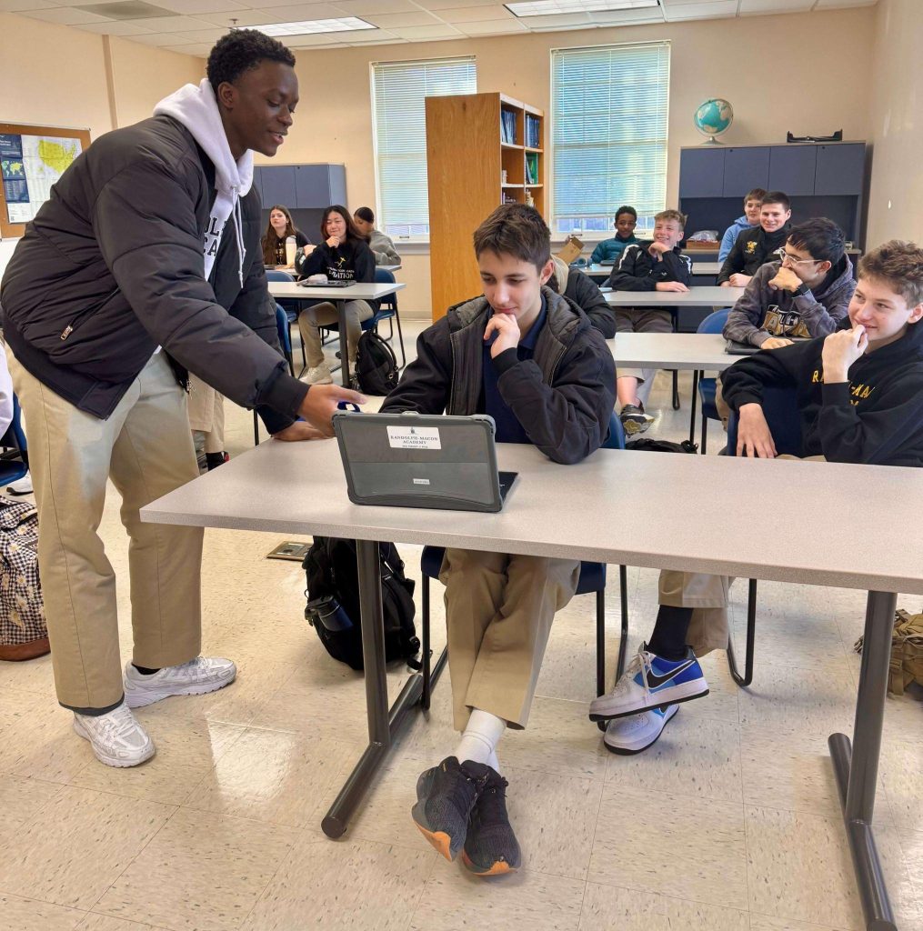 A pair of R-MA students using a tablet during a classroom activity that supports academic skills, test preparation, and college readiness.