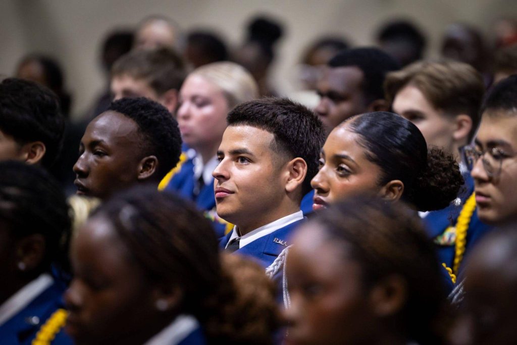 A hall of Randolph-Macon Academy cadets listening attentively during a school event, demonstrating focus, discipline, and student leadership.
