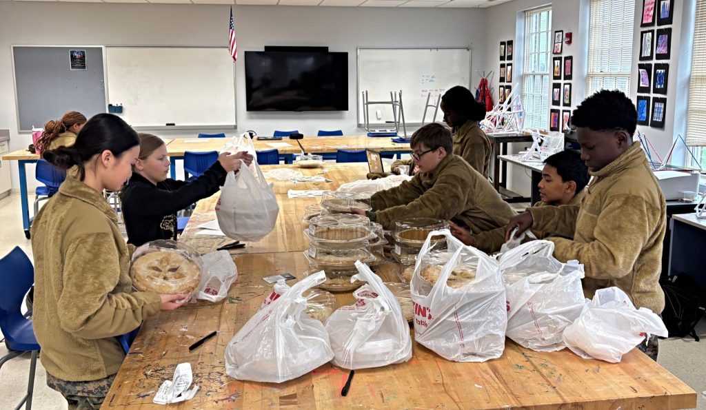 Students participating in a small group project during a club, highlighting extracurricular activities for high school students, and student collaboration