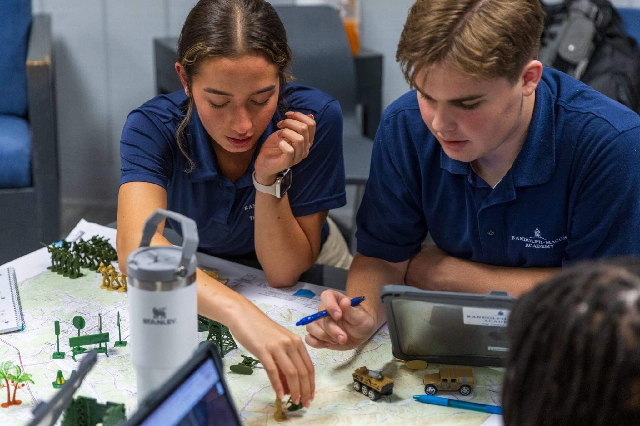 A pair of R-MA students collaborating on a hands-on planning exercise that develops critical thinking, teamwork, and problem-solving skills.