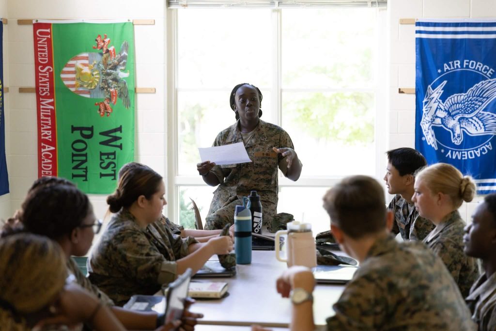 R-MA cadet leading a discussion with fellow cadets during a classroom leadership session.